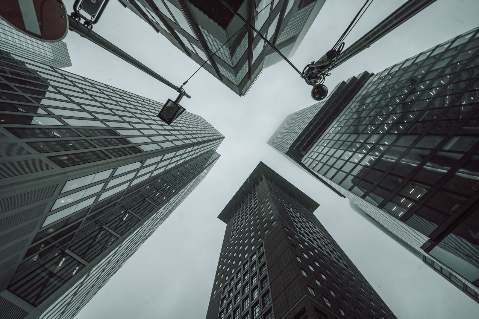 Office towers photographed from directly below against an overcast sky